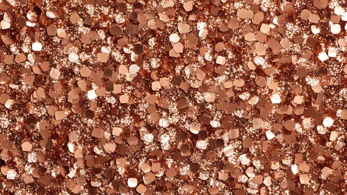 Copper glitter surface shows dense metallic confetti layer