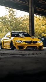 Lowered yellow sports coupe under industrial canopy in bokeh light
