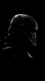 Shadowed sci fi helmet dissolving into textured darkness.