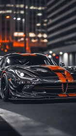 Carbon black supercar cuts through neon lit urban night street