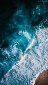 Roaring turquoise surf rolls onto a sunlit sandy shore.