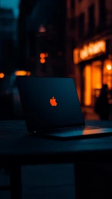 Sleek laptop glows in neon city night ambience.