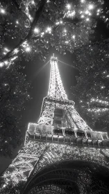 Eiffel Tower night view framed by illuminated tree canopy.