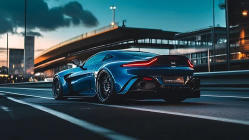 Low-angle dusk capture of aerodynamic blue sports coupe on urban highway