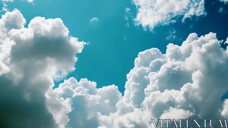 Bright cumulus clouds in vibrant blue sky, natural scenic view.