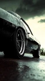 Muscle car silhouette on wet asphalt under storm sky.
