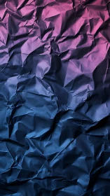 Crumpled paper surface with pink to blue gradient lighting.