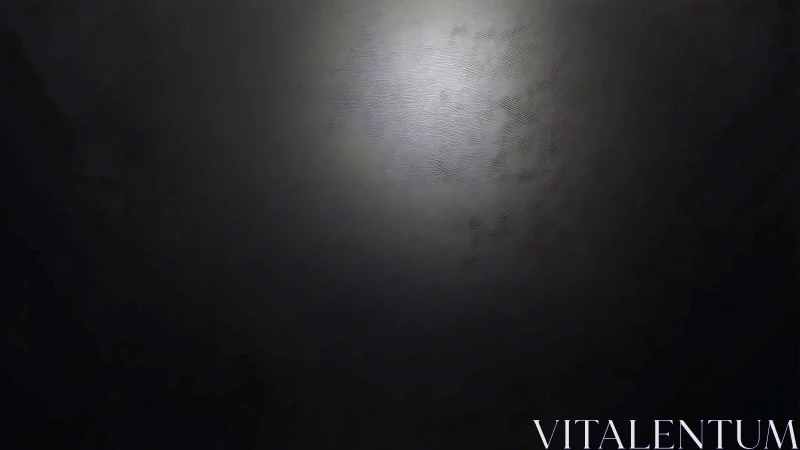 Specular gradient on textured dark surface under diffuse light.