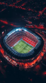 Football stadium glows under intense red night lighting