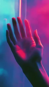 Hand raised in neon pink and blue colored light glow.