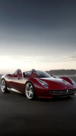 Aerodynamic crimson roadster under gradient coastal sky.