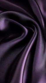 Close-up of folded dark purple satin fabric surface.