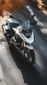 Adventure touring motorcycle in warm directional sunlight.