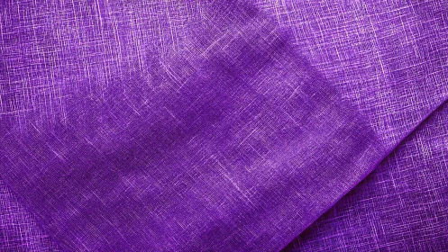 Macro closeup of folded purple crosshatch woven linen textile