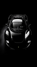 Gleaming black sports car glows softly against deep shadow