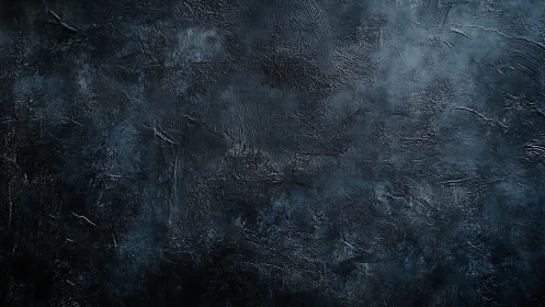 Textured dark plaster surface reveals subtle tonal gradations