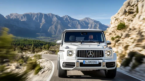 High-performance Mercedes SUV tracked head-on on winding mountain road