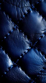 Deep blue quilted leather texture with glossy highlights.