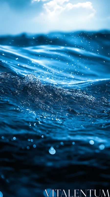 Surface-tension microcrest on sunlit deep-ocean wavefront.