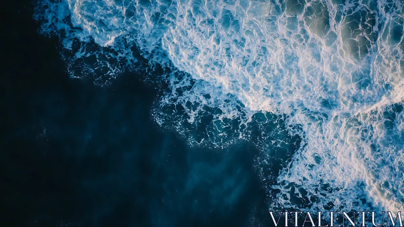 Crashing ocean waves churn against deep blue open water