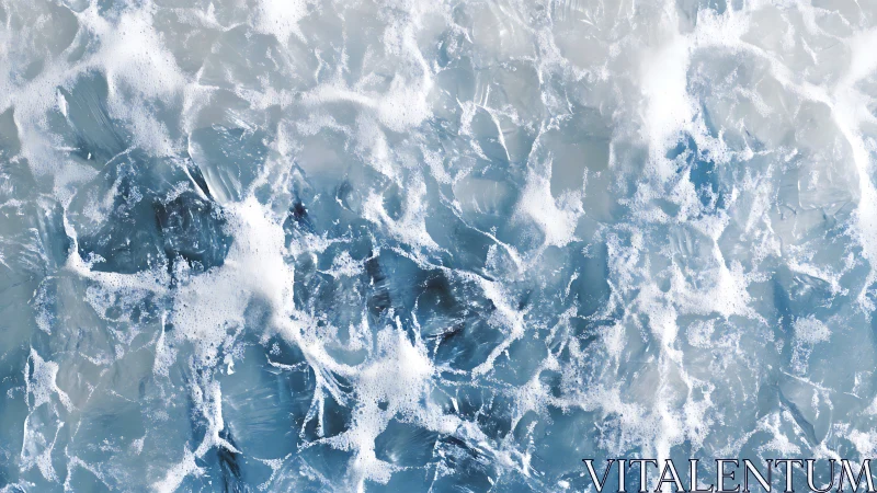 Gentle sea foam dancing over swirling blue ocean waves.