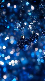 Blue glass ornaments in luminous holiday bokeh field.