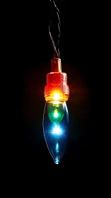 Illuminated multicolor decorative bulb on dark background.