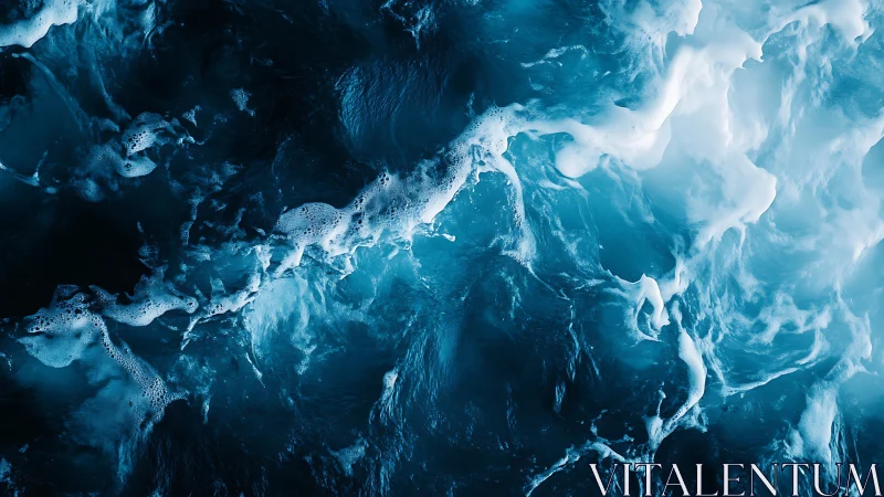 Aerial view of churning blue ocean waves in motion.