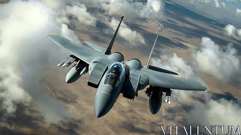 Twin‑engine strike fighter aircraft cruising above scattered cumulus