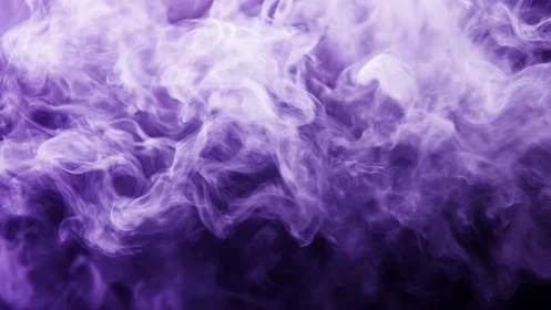 Abstract purple smoke swirling on dark background in soft focus.