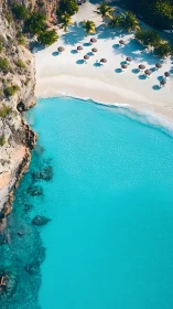 Turquoise cove with white sand beach and parasol shadows