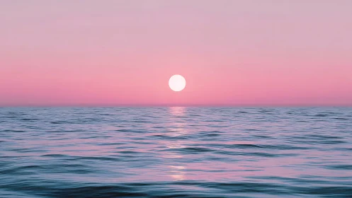 Soft pink ocean horizon welcomes a calm glowing sunset