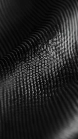 Closeup of dark textured surface with repeating ridges.