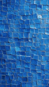 Irregular blue ceramic mosaic wall forms undulating grid surface