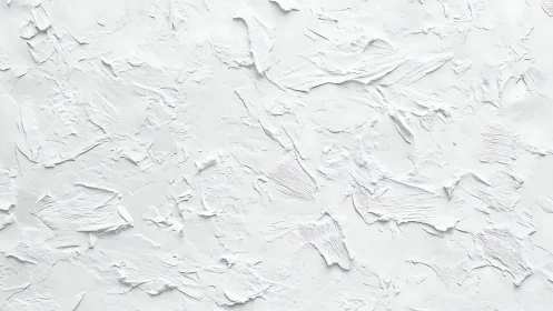 White textured plaster wall shows sculpted abstract surface.
