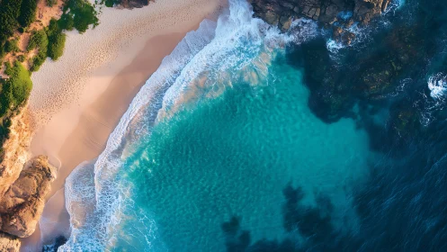 Turquoise cove meets sandy beach under rugged coastal cliffs
