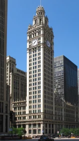 Historic clock tower skyscraper amid modern cityscape.
