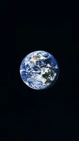 Solitary blue Earth suspended in deep black space.