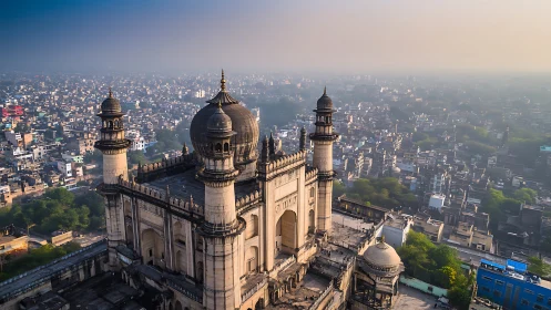 Historic mosque dominates dense urban skyline at sunrise.