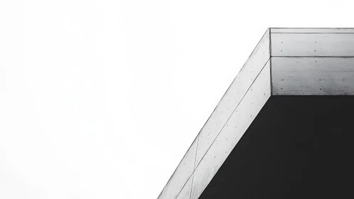 Minimalist concrete roof edge against white sky backdrop.
