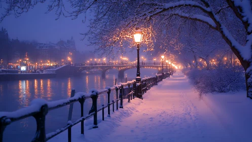 Snow covered riverside promenade under warm streetlights