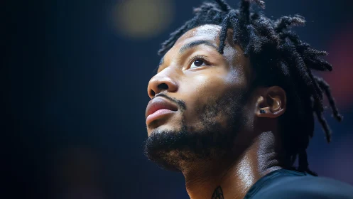 Sweat-lit basketball dreamer studies the rafters before battle