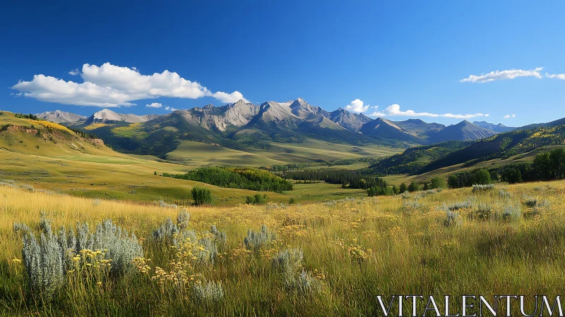 Mountain valley landscape under clear blue sky panorama.