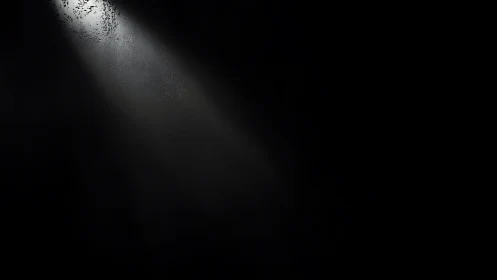 Single bright light beam cutting through deep darkness.