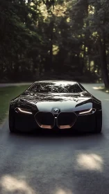 Low frontal view of sleek black concept coupe on road.
