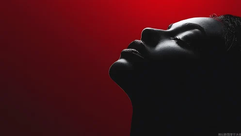 Silhouetted profile savors calm light against deep red glow