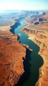 Aerial desert canyon river corridor with stratified sandstone walls