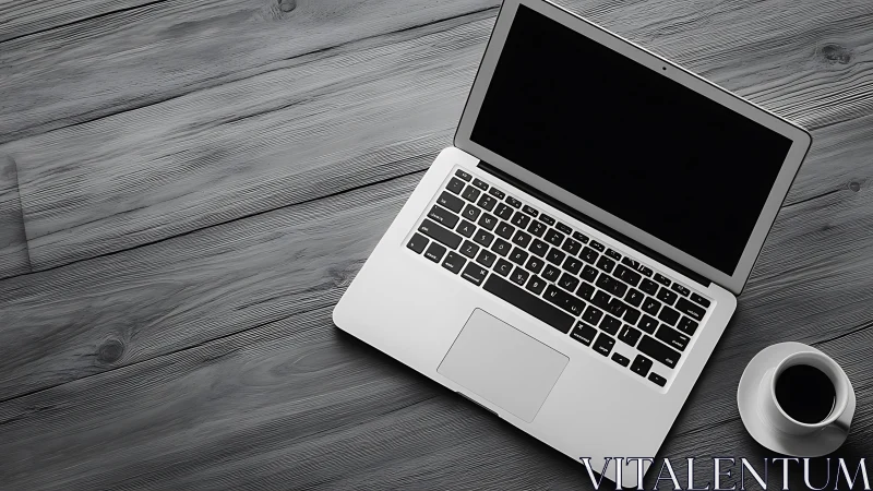 Quiet laptop and coffee inviting a calm workday moment.