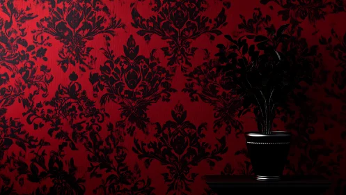 Low-key potted plant silhouetted against high-contrast baroque wallpaper