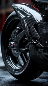 Carbon fiber supersport rear assembly with wet-surface reflections.